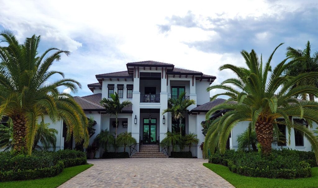 pexels photo 12558848 A stunning modern residential building with palm trees and clean architectural design.