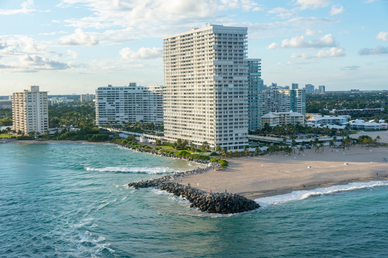 why-choose-us Aerial view of Bal Harbour beachfront and skyscrapers in Miami, Florida at daytime.