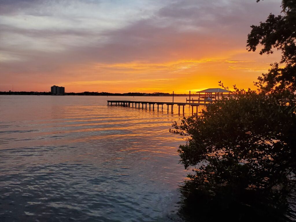 pexels photo 5736576 Beautiful sunset view over a pier at Daytona Beach, Florida with golden hues reflecting on the water.